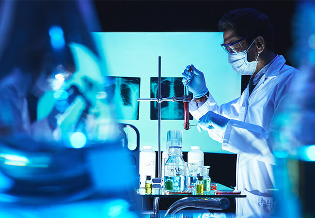 Doctor adding reagent in test-tube